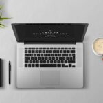 Minimalist workspace with laptop, notebook, and coffee cup representing a clutter-free digital life.