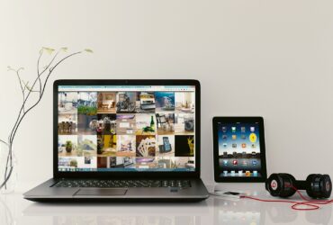Minimalist desk setup with headphones and laptop for focus.