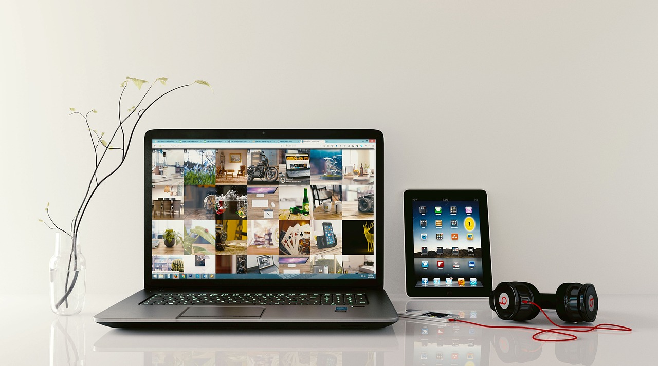 Minimalist desk setup with headphones and laptop for focus.